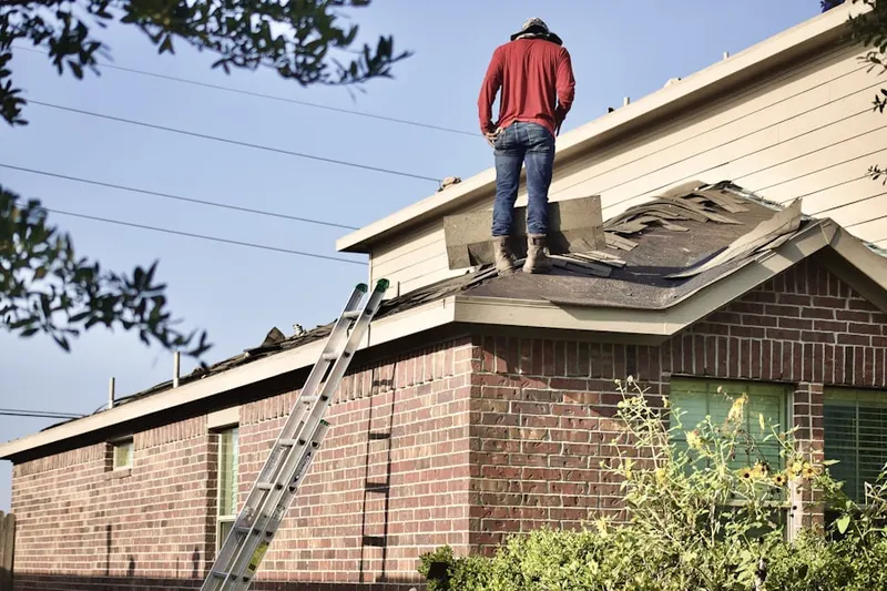 Professional roofer working on a residential roof in Strathmore Woods